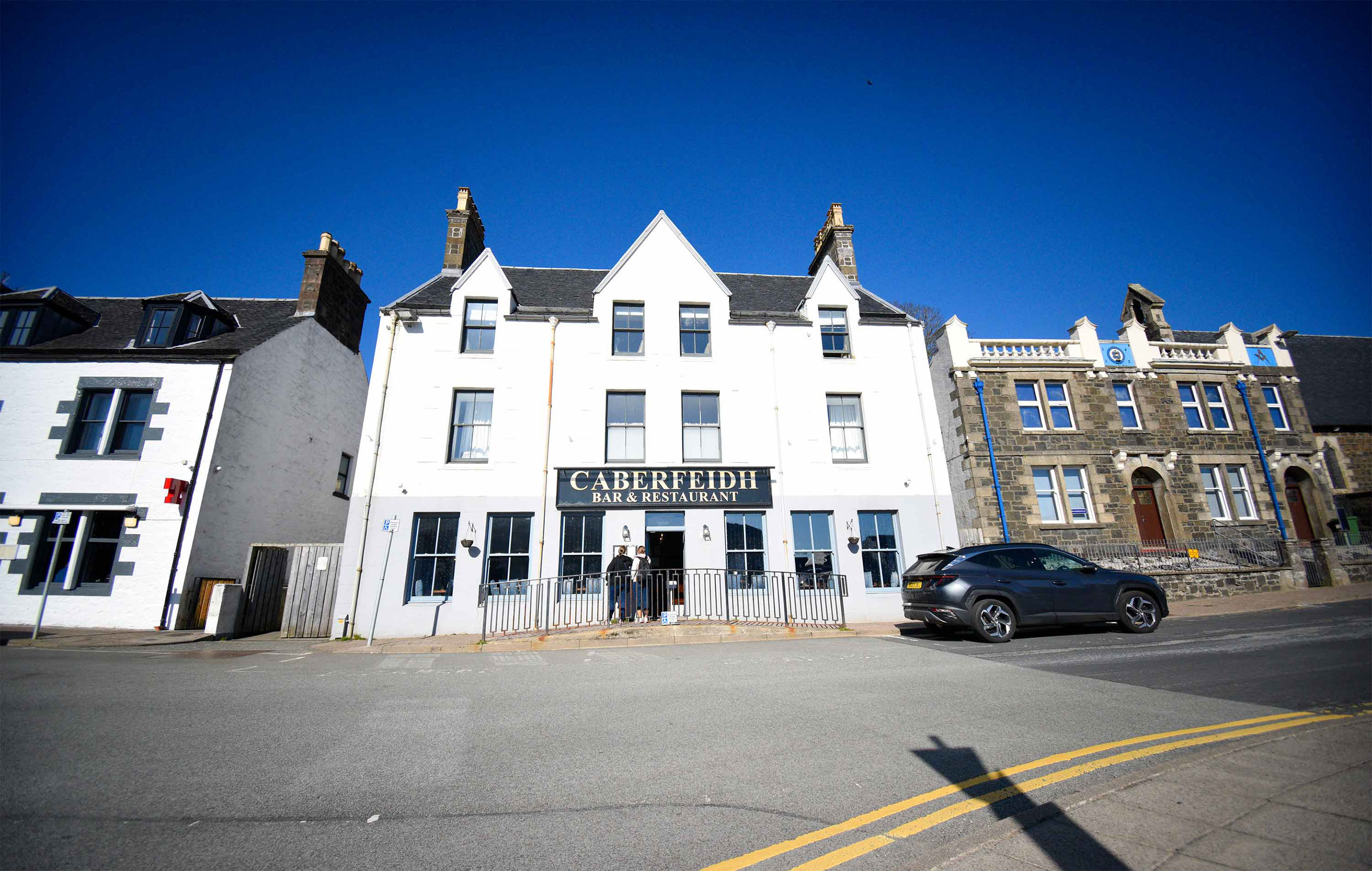 Relax in Taransay House Luxury Accommodation in Portree public seating area with woodburning stove