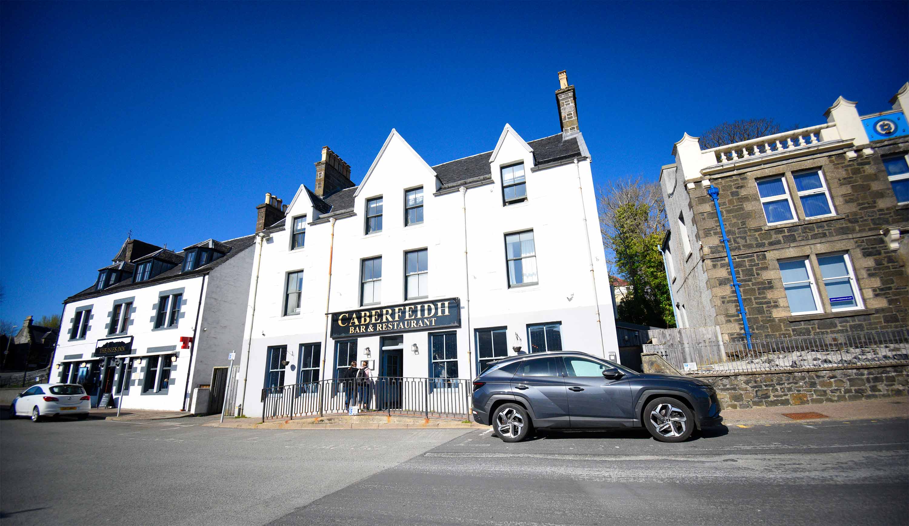 Relax in Taransay House Luxury Accommodation in Portree public seating area with woodburning stove