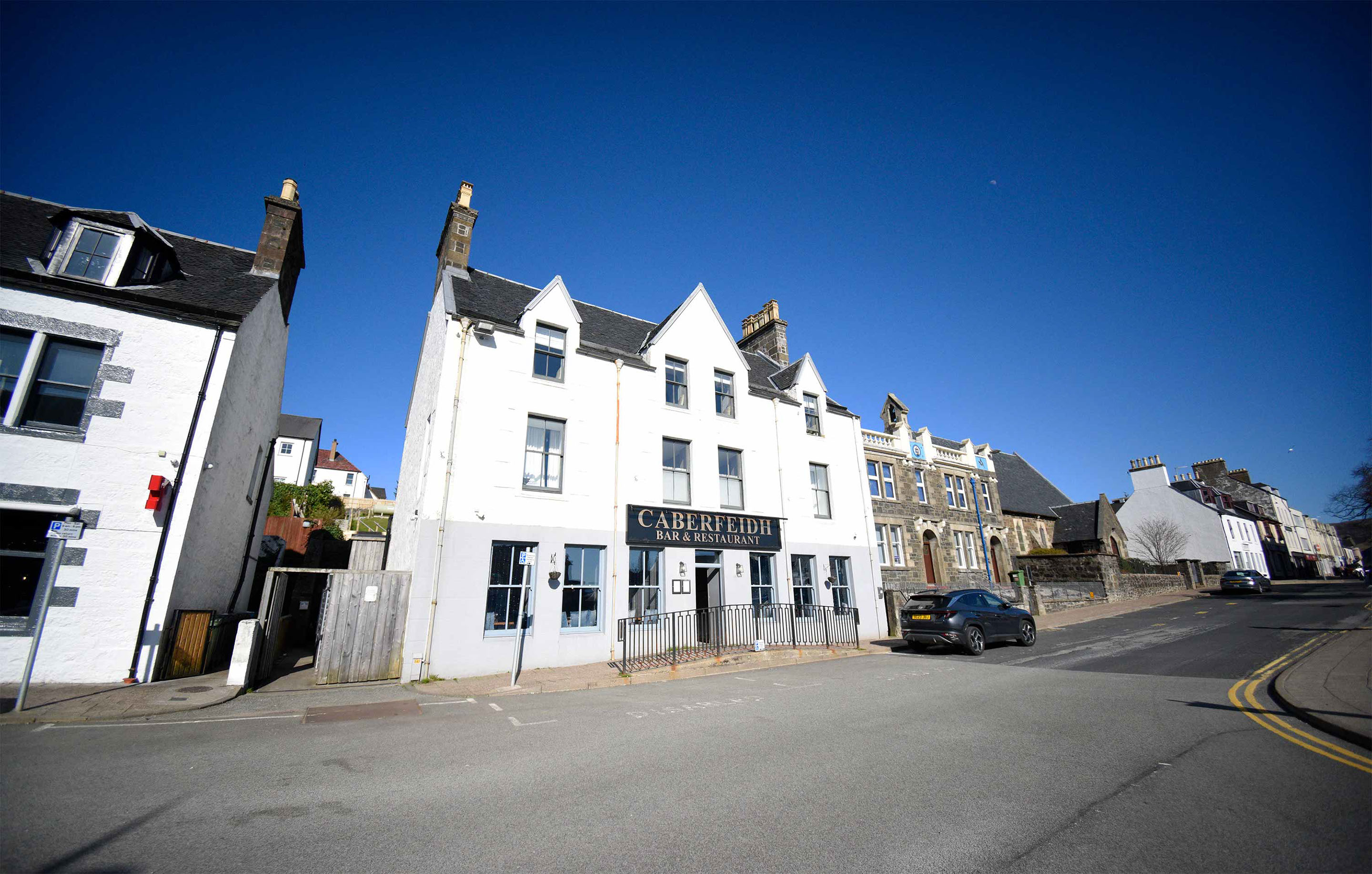 Relax in Taransay House Luxury Accommodation in Portree public seating area with woodburning stove