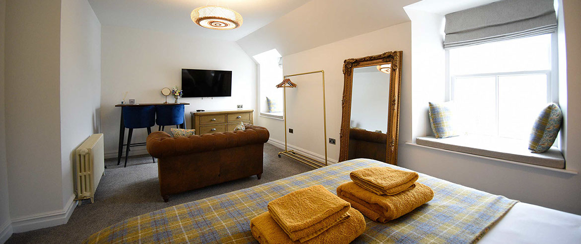 Somerled House Suites Room 5 contains a widescreen smart TV and cosy seating area at our Portree accommodation