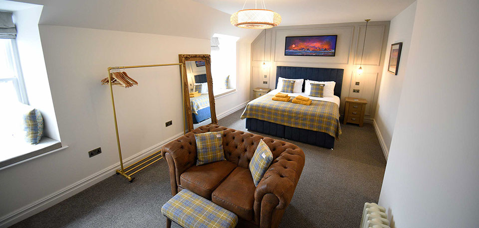 Somerled House Suites contain a King size bed with all bedding and linen provided and a cost seating area with widescreen TV